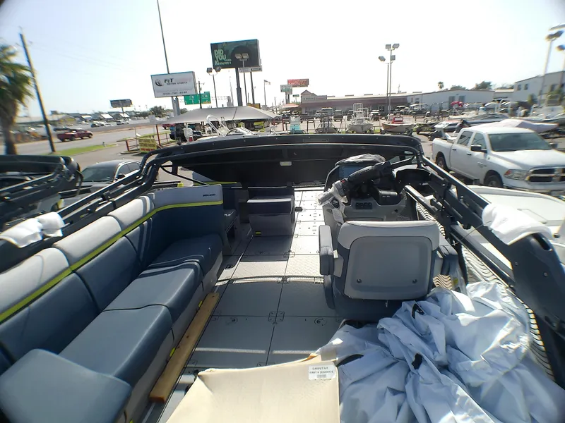 Slide: The Image of 2025 Sea-Doo 55SL boat interior with seating and control panel, parked outdoors. - 7