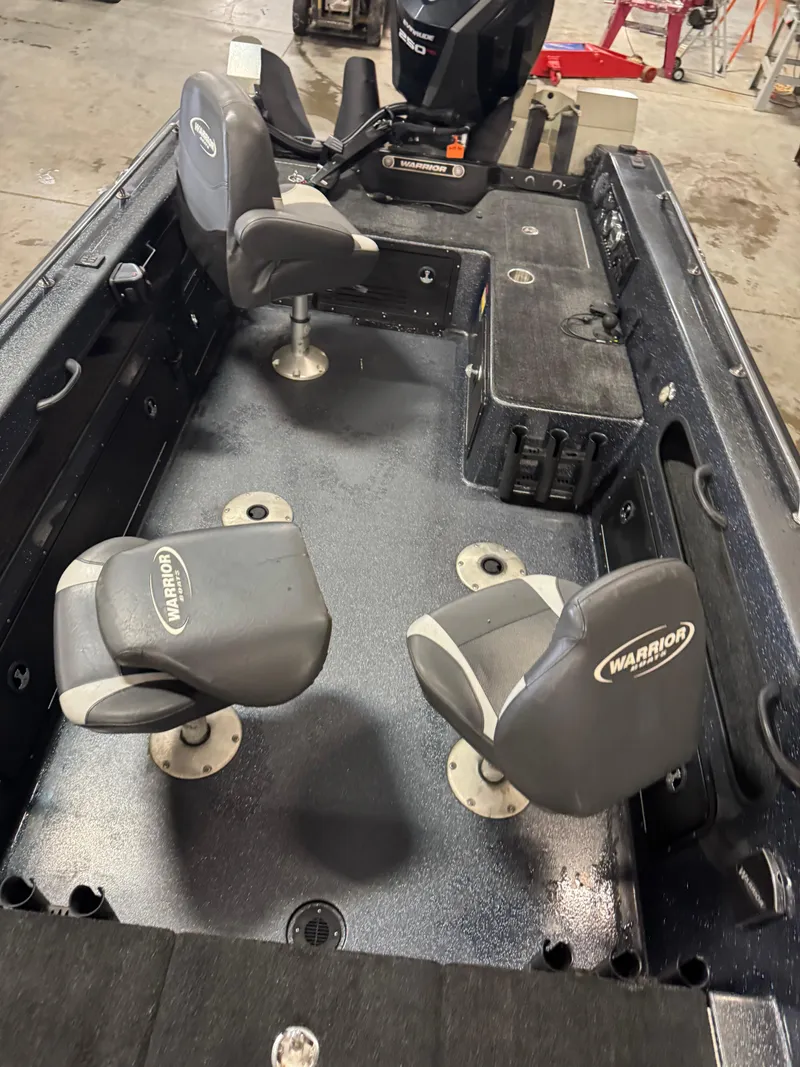 Slide: The Image of 2017 Warrior V2090 boat interior with two swivel seats and a motor. - 12