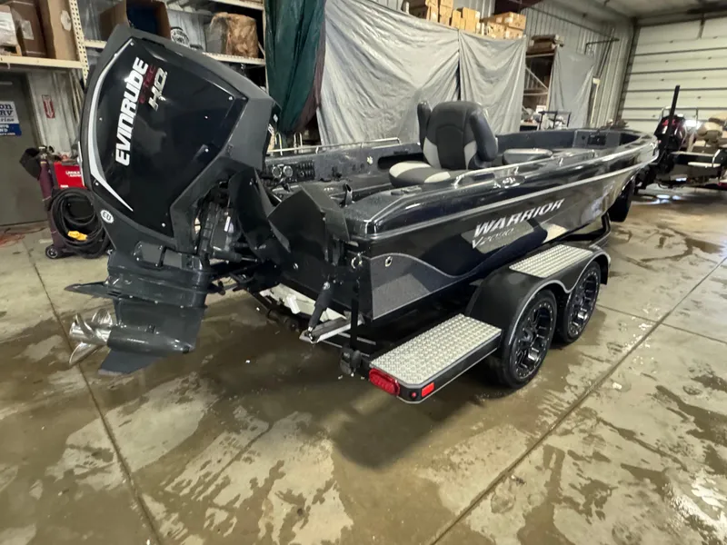 Slide: The Image of 2017 Warrior V2090 boat with Evinrude engine in a garage setting. - 2