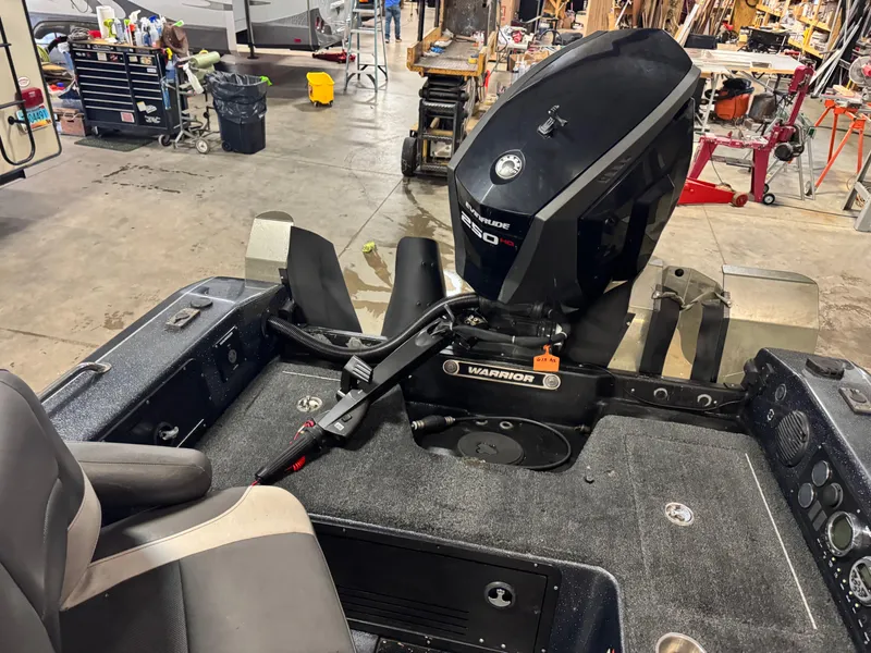 Slide: The Image of 2017 Warrior V2090 boat with Evinrude 250 HP engine in a workshop setting. - 7