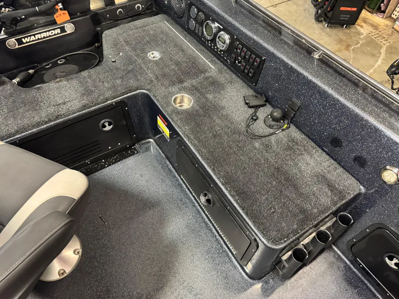 Slide: The Image of Interior of a 2017 Warrior V2090 boat, featuring control panel and seating area. - 8