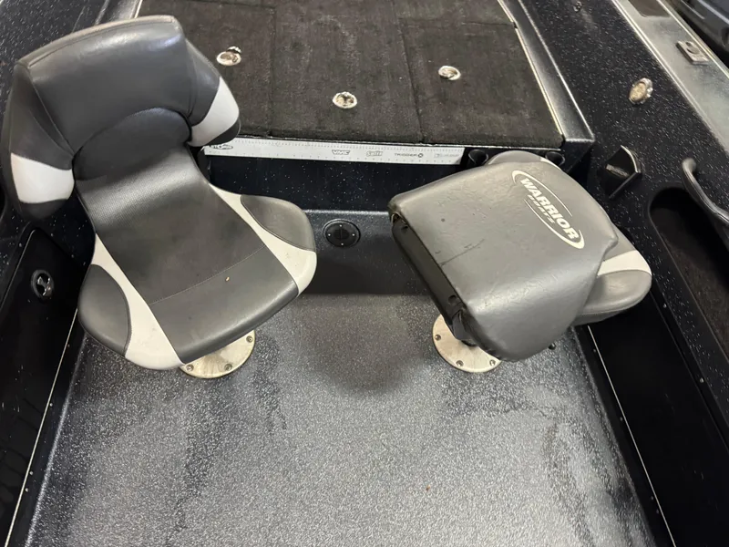 Slide: The Image of 2017 Warrior V2090 boat interior with two gray seats and textured flooring. - 9