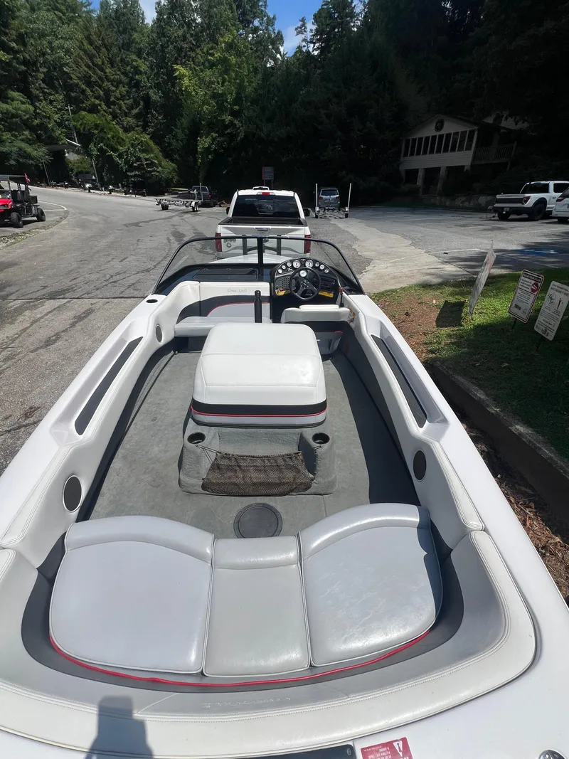 Slide: The Image of 1997 Correct Craft Ski Nautique 196 boat interior with seating and dashboard, parked outdoors. - 3