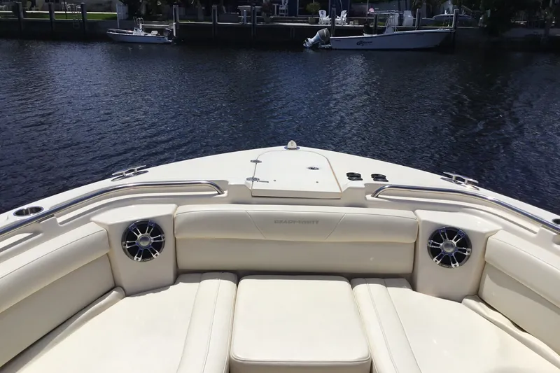 Slide: The Image of 2022 Grady-White Freedom 325 boat interior with plush seating and water view. - 23