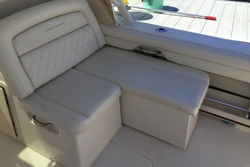 Slide: The Image of 2022 Grady-White Freedom 325 boat interior with cushioned seating and storage. - 59