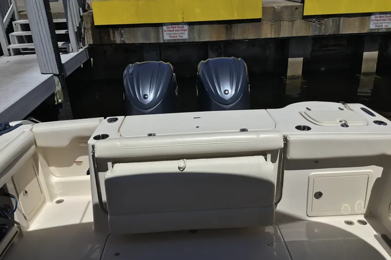 Slide: The Image of 2022 Grady-White Freedom 325 boat interior with dual outboard motors at dock. - 61