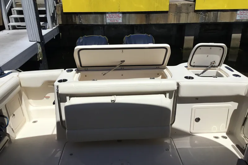 Slide: The Image of 2022 Grady-White Freedom 325 boat interior with open storage compartments at dock. - 62