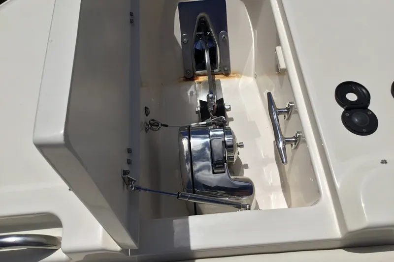 Slide: The Image of Anchor compartment of 2022 Grady-White Freedom 325 boat, featuring polished metal components. - 30