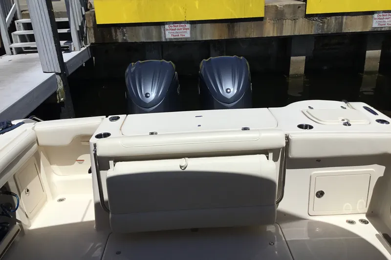 Slide: The Image of 2022 Grady-White Freedom 325 boat interior with dual outboard motors at dock. - 60