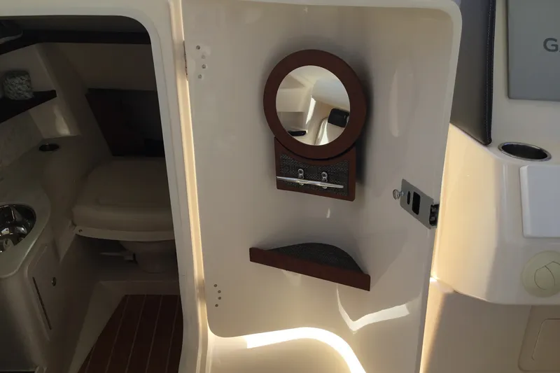 Slide: The Image of 2022 Grady-White Freedom 325 boat interior with mirror and seating area. - 45