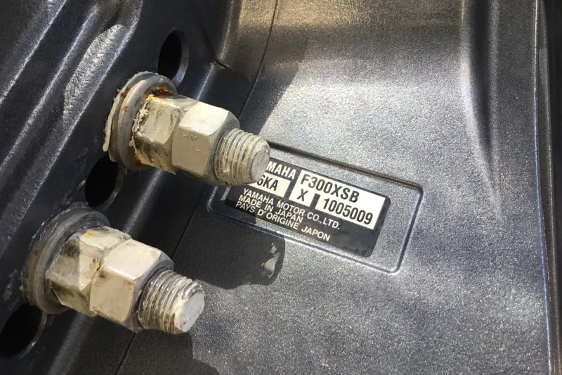 Slide: The Image of Close-up of Yamaha F300XSB engine bolts on a 2022 Grady-White Freedom 325 boat. - 78