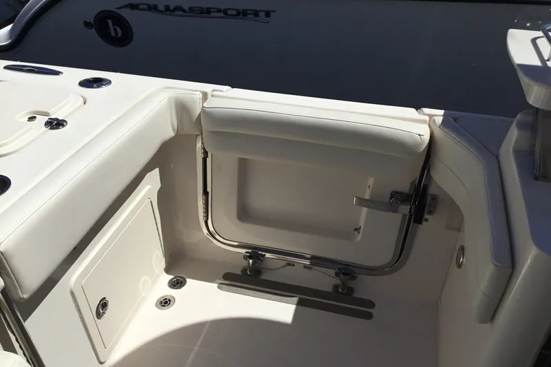 Slide: The Image of 2022 Grady-White Freedom 325 boat interior with white seating and storage compartment. - 64