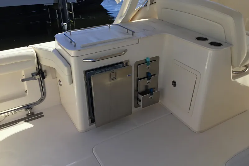 Slide: The Image of 2022 Grady-White Freedom 325 boat interior with storage compartments and seating area. - 57