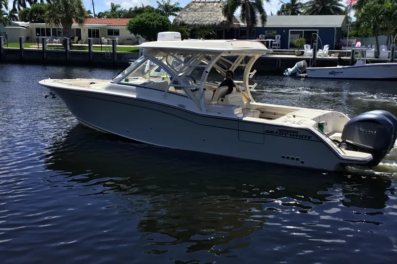 Slide: The Image of 2022 Grady-White Freedom 325 boat cruising on a sunny waterfront. - 20
