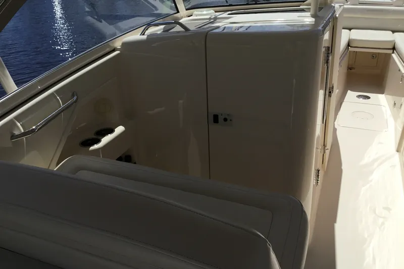 Slide: The Image of 2022 Grady-White Freedom 325 boat interior with seating and storage compartments. - 41