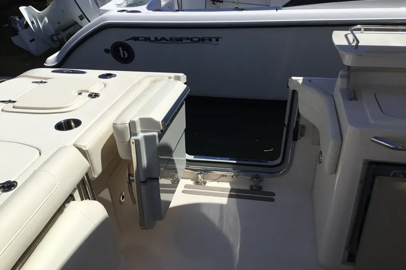 Slide: The Image of 2022 Grady-White Freedom 325 boat interior with open side door and seating area. - 67