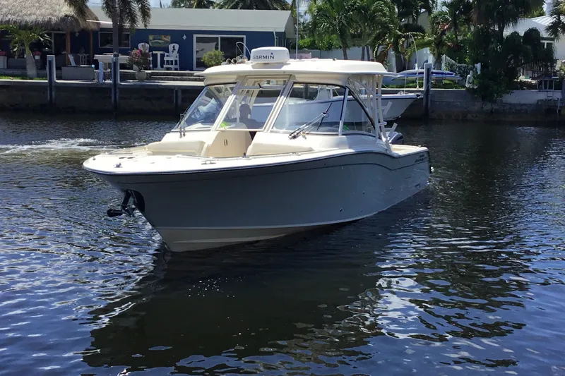 Slide: The Image of 2022 Grady-White Freedom 325 boat cruising on a calm waterway. - 15