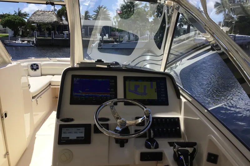 Slide: The Image of Interior view of 2022 Grady-White Freedom 325 boat cockpit with navigation screens. - 51
