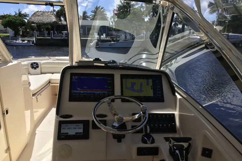 Slide: The Image of Interior view of 2022 Grady-White Freedom 325 boat cockpit with navigation screens. - 52