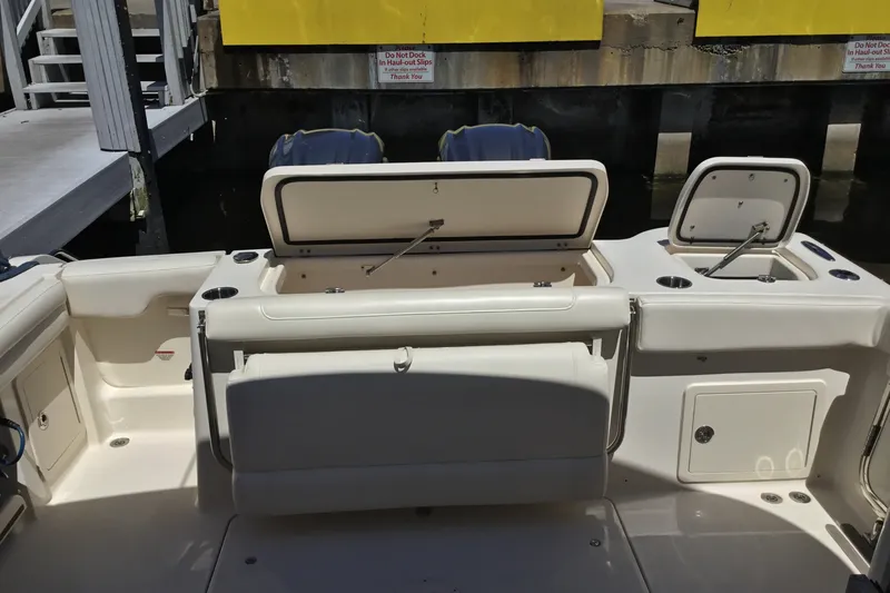 Slide: The Image of 2022 Grady-White Freedom 325 boat interior with open storage compartments and seating. - 63