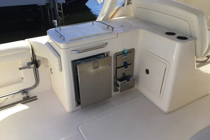 Slide: The Image of 2022 Grady-White Freedom 325 boat interior with storage and seating area. - 56