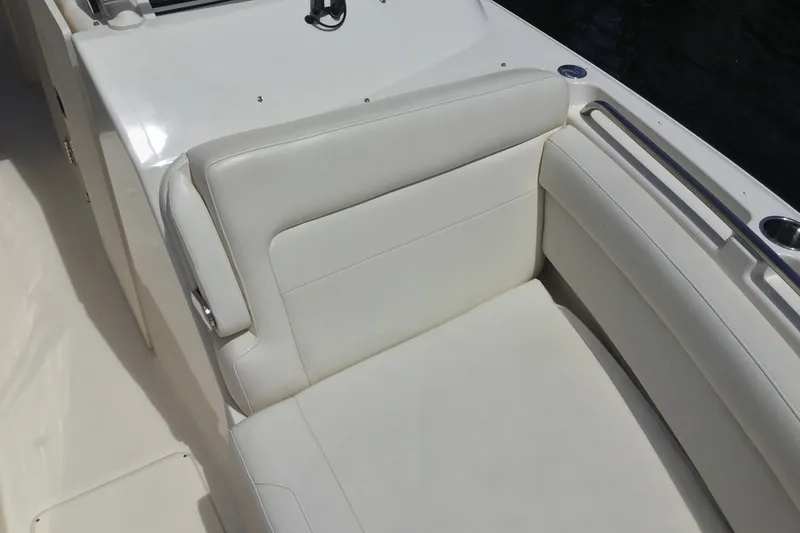 Slide: The Image of 2022 Grady-White Freedom 325 boat interior with white cushioned seating. - 27