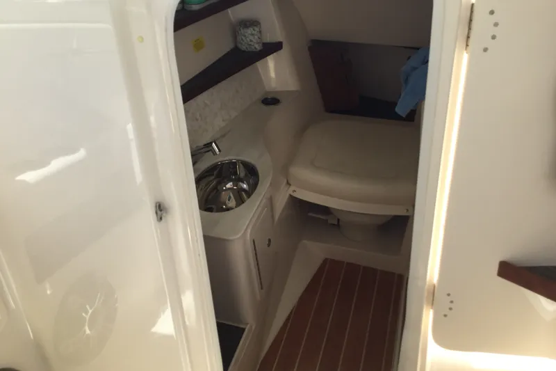 Slide: The Image of 2022 Grady-White Freedom 325 boat interior with compact bathroom and sink. - 42