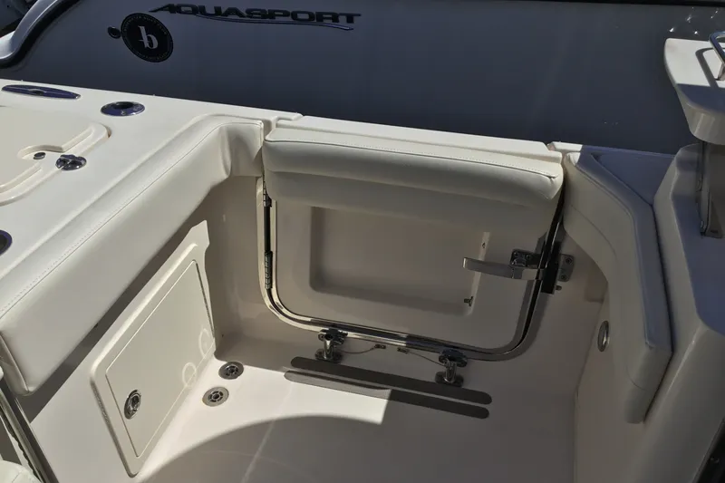 Slide: The Image of 2022 Grady-White Freedom 325 boat interior, featuring sleek seating and storage compartments. - 65