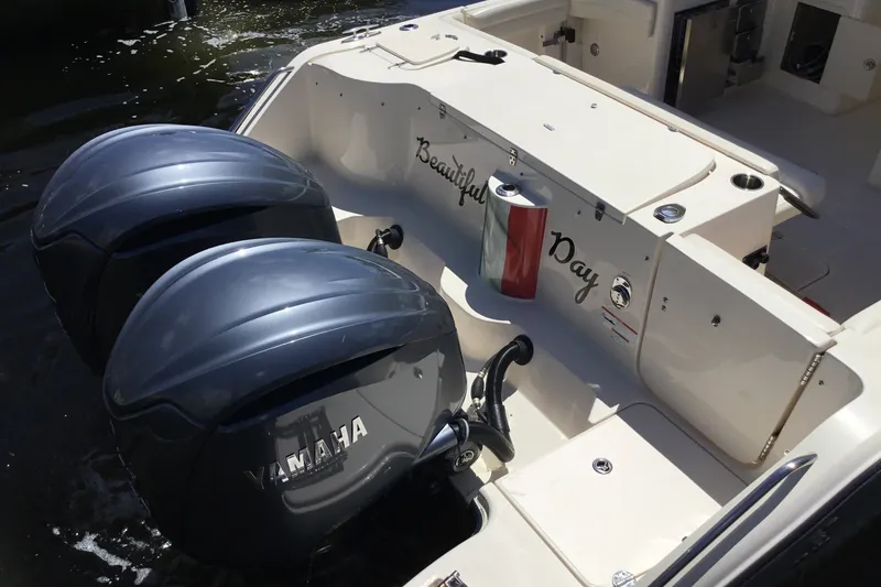 Slide: The Image of 2022 Grady-White Freedom 325 boat with Yamaha engines, docked on water. - 22
