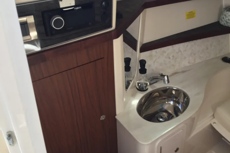 Slide: The Image of 2022 Grady-White Freedom 325 boat interior with sink and wooden cabinetry. - 43