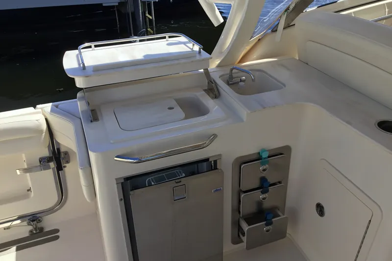 Slide: The Image of 2022 Grady-White Freedom 325 boat interior with sink and storage compartments. - 58
