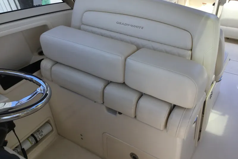 Slide: The Image of 2022 Grady-White Freedom 325 boat interior with luxurious seating and steering wheel. - 49