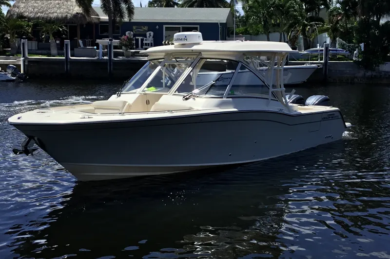 Slide: The Image of 2022 Grady-White Freedom 325 boat cruising on a sunny waterfront. - 17