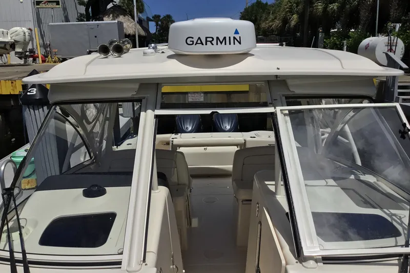 Slide: The Image of 2022 Grady-White Freedom 325 boat with Garmin navigation, docked in a marina setting. - 24