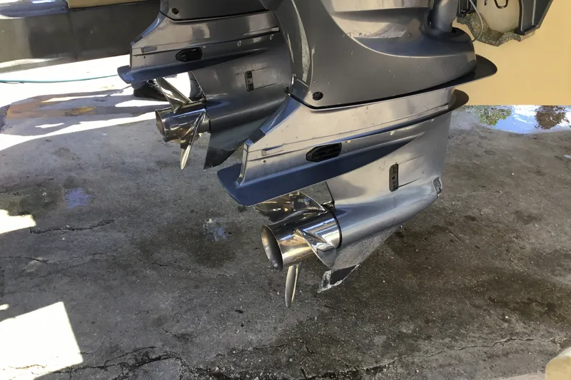 Slide: The Image of Twin outboard motors on a 2022 Grady-White Freedom 325 boat, parked on concrete. - 80