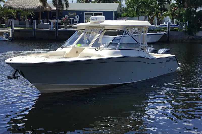 Slide: The Image of 2022 Grady-White Freedom 325 boat cruising on a sunny day near a dock. - 16