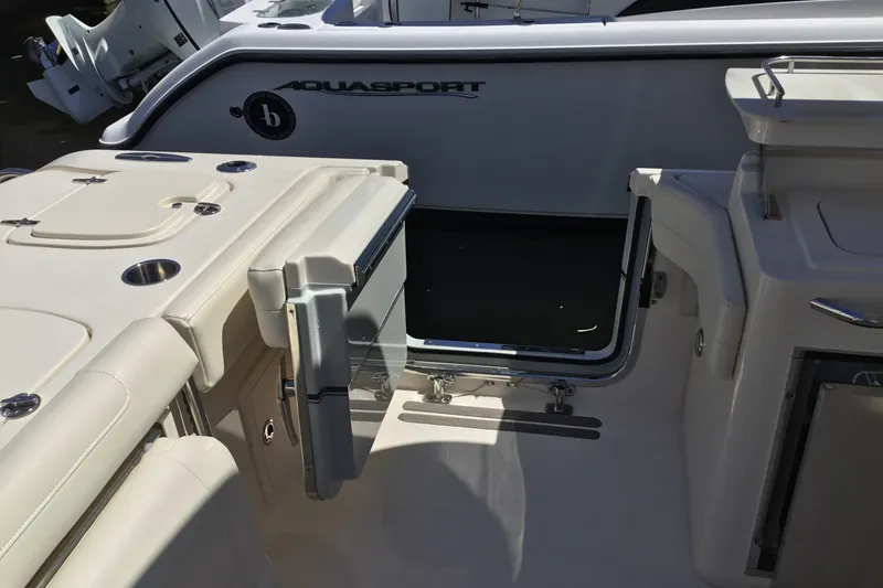 Slide: The Image of 2022 Grady-White Freedom 325 boat interior with open door and seating area. - 68