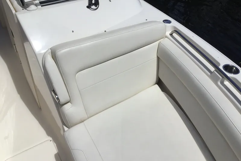 Slide: The Image of 2022 Grady-White Freedom 325 boat with white cushioned seating and stainless steel cup holders. - 26