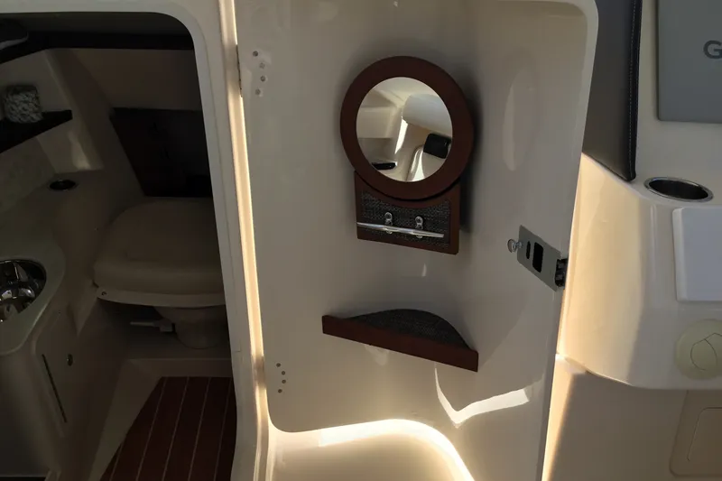 Slide: The Image of 2022 Grady-White Freedom 325 boat interior with compact bathroom and mirror. - 46