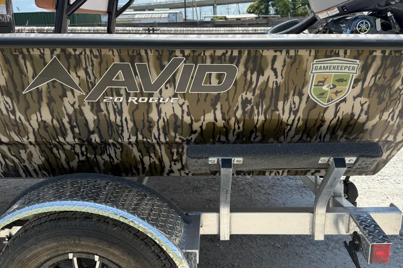 Slide: The Image of Camouflage Avid 20 Rogue CC boat on trailer, featuring Gamekeeper logo, 2026 model. - 3