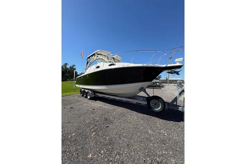 Slide: The Image of 2015 Wellcraft 290 Coastal boat on trailer under clear blue sky. - 20