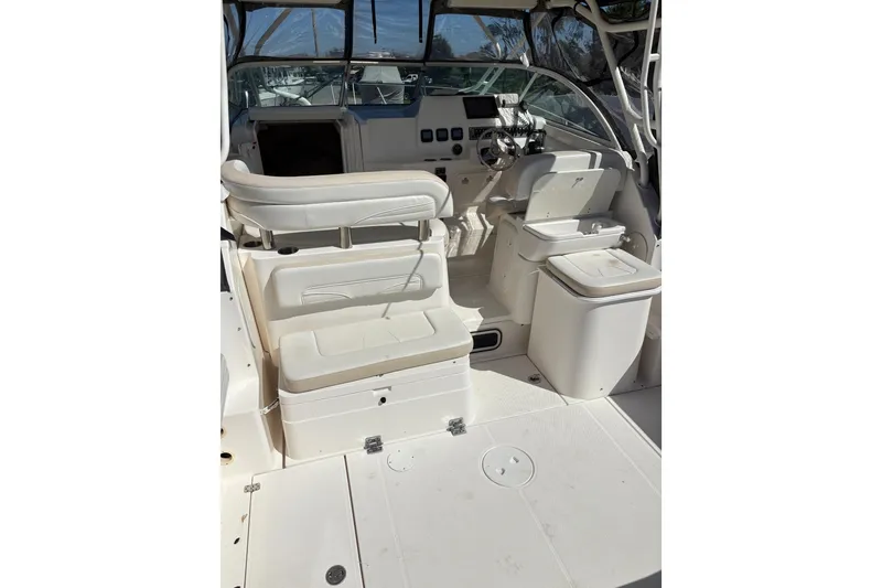 Slide: The Image of 2015 Wellcraft 290 Coastal boat interior with helm, seating, and storage compartments. - 25