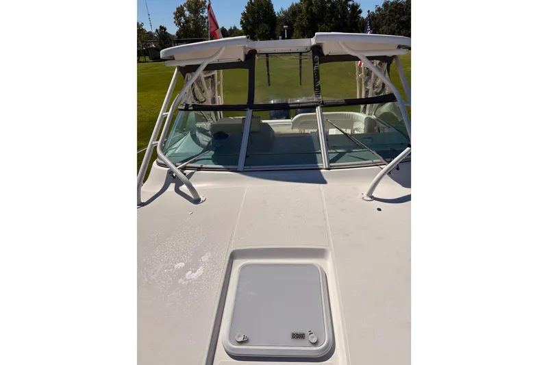 Slide: The Image of 2015 Wellcraft 290 Coastal boat deck with windshield and hatch, outdoors. - 52