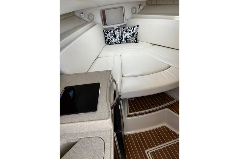 Slide: The Image of 2015 Wellcraft 290 Coastal cabin interior with white seating and patterned cushions. - 53