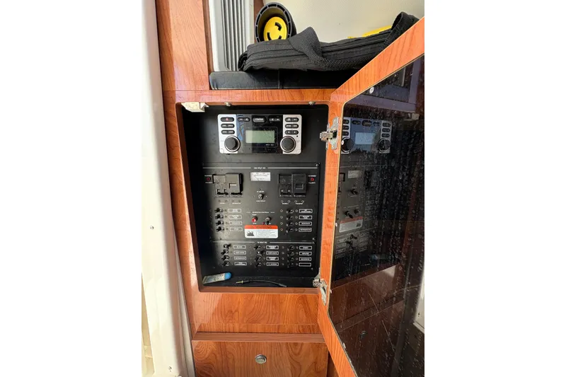 Slide: The Image of Electrical control panel inside 2015 Wellcraft 290 Coastal boat, featuring various switches and controls. - 55
