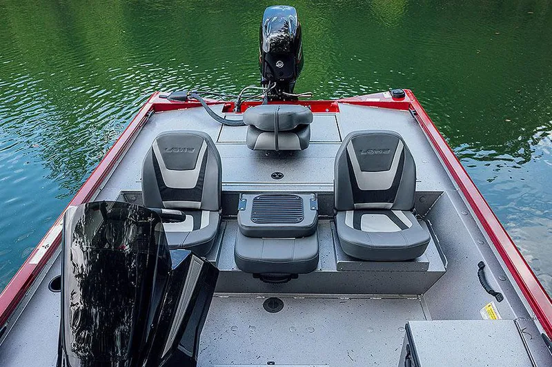 Slide: The Image of Manufacturer Provided Image: 2025 Lowe Stinger 175C boat interior with seating, on calm green water. - 10