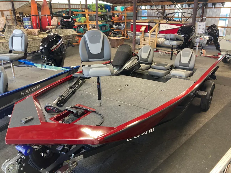 Slide: The Image of 2025 Lowe Stinger 175C fishing boat in showroom, featuring sleek design and comfortable seating. - 4