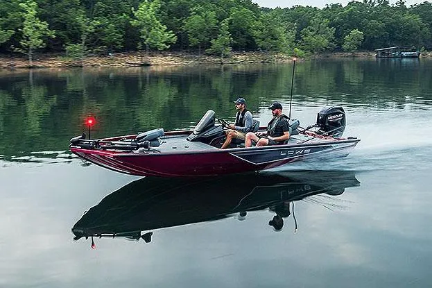 Slide: The Image of Manufacturer Provided Image: 2025 Lowe Stinger 175C boat cruising on a calm lake with two passengers. - 5
