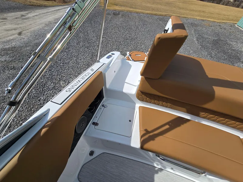 Slide: The Image of 2025 Four Winns H1 boat interior with tan seating and sleek design. - 12