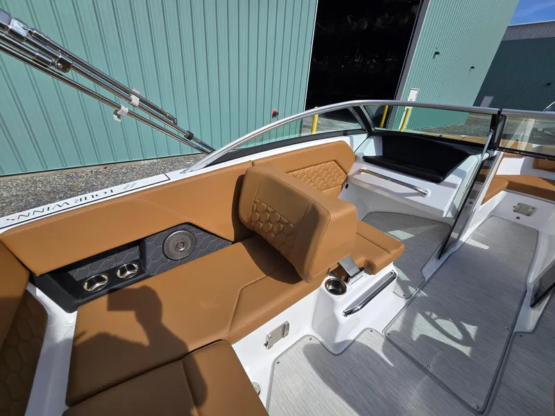 Slide: The Image of 2025 Four Winns H1 boat interior with tan seating and modern design. - 15